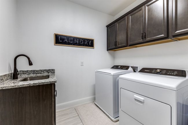 Spacious laundry room with sink and cabinetry | Image 10