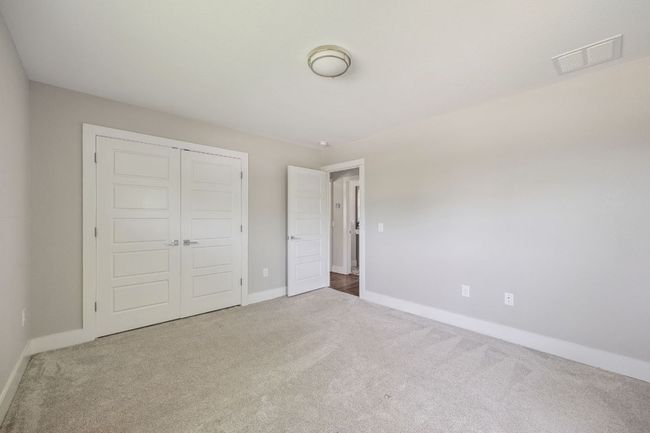 Unfurnished bedroom with carpet flooring and a closet | Image 30