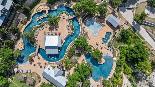 THIS COMMUNITY POOL HAS A LAZY RIVER AND HUGHE SLIDE FOR OUT DOOR FUN | Image 29