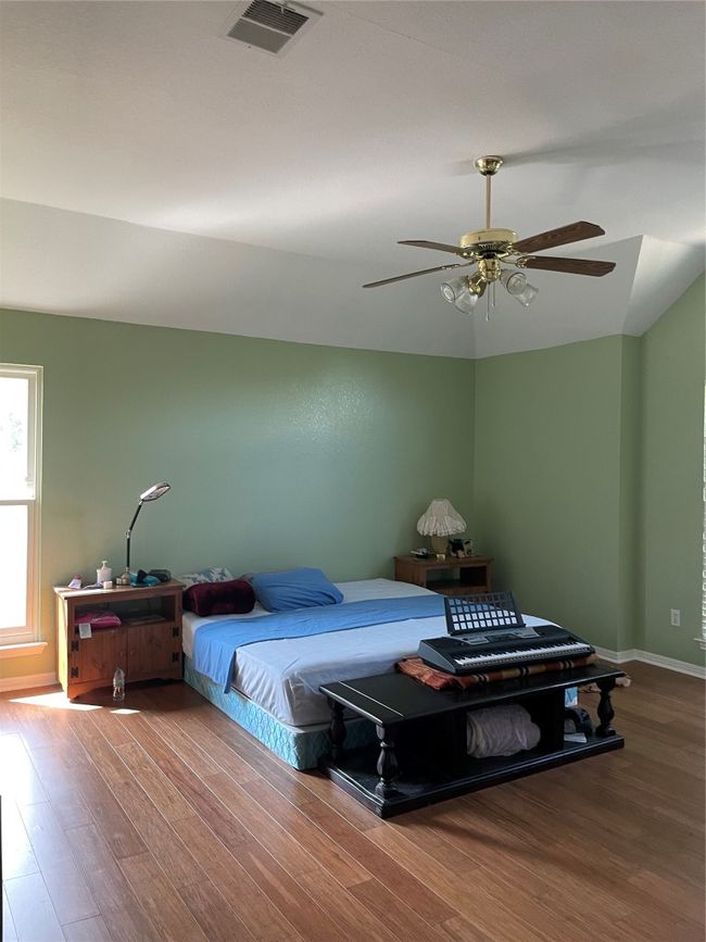 Bedroom featuring wood finished floors and a ceiling fan | Image 5