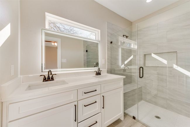 Bathroom featuring a stall shower, double vanity, and a ceiling fan | Image 24