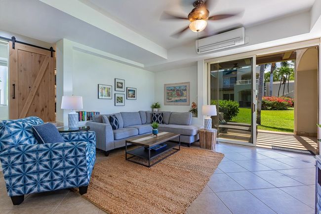 The light-filled great room in this ground-floor furnished unit offers beautiful pastoral views | Image 5