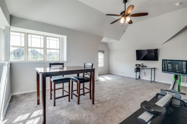 Carpeted dining space with vaulted ceiling and a ceiling fan | Image 14