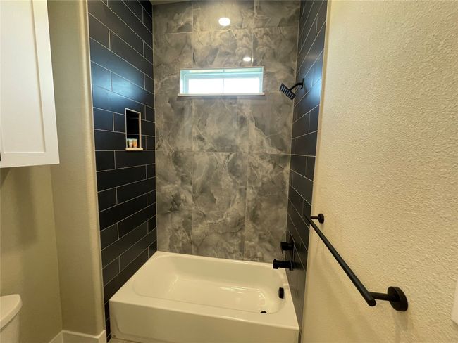 Full bath with separated by pocket door features dramatic porcelain wall | Image 27