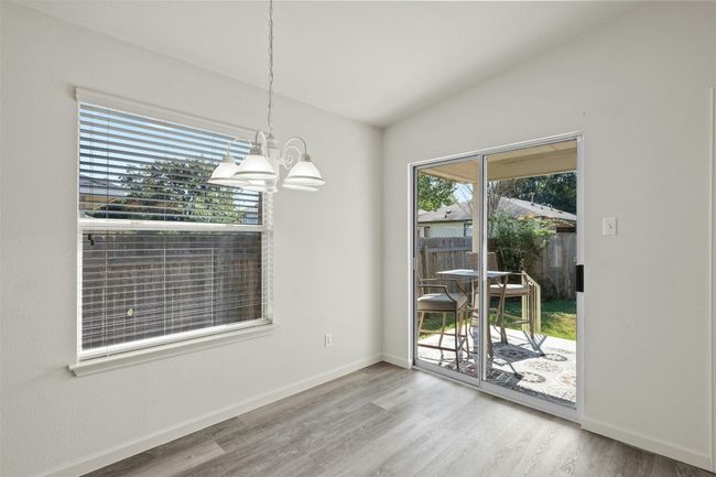 The dining room is flooded with natural light and can comfortably fit a table of six. | Image 15
