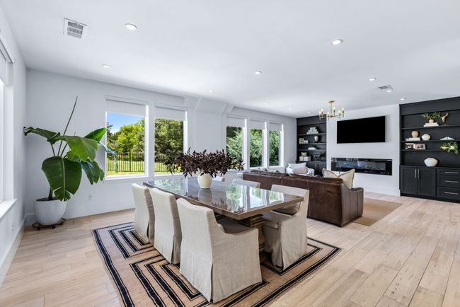 Dining room with a chandelier, light wood-style flooring, recessed lighting, and built in features | Image 12