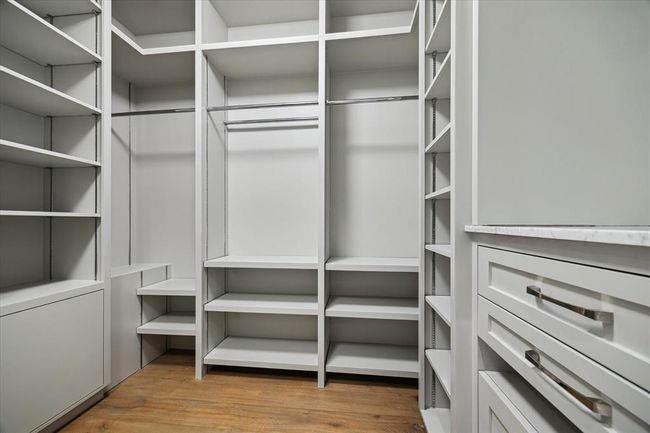 All secondary bedroom closets feature thoughtfully designed custom built-ins, offering abundant hanging space, shelving, and drawer storage—providing both organization and style. | Image 30