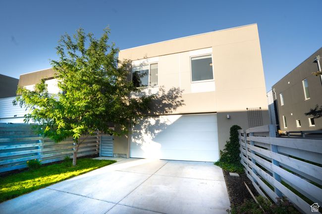 View of front of home featuring stucco siding, a garage, and concrete driveway | Image 38