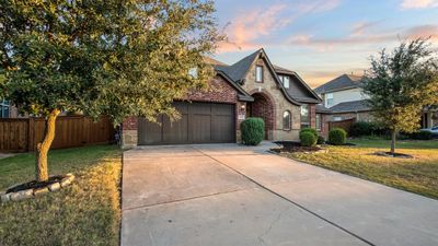 View of front of property featuring a garage and a lawn | Image 3