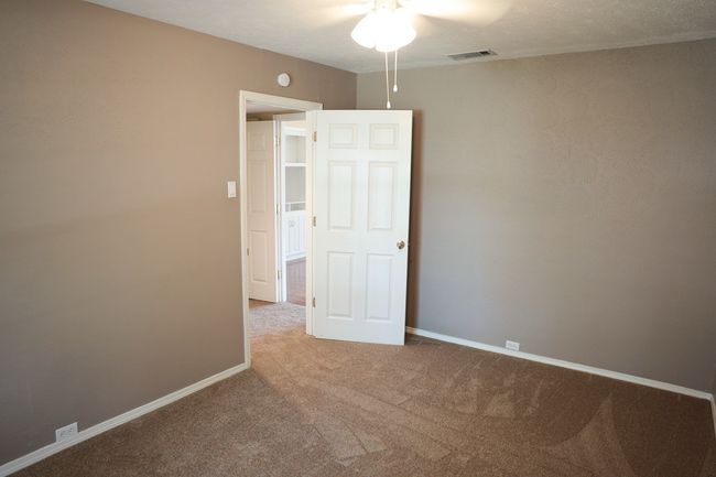 Unfurnished room featuring a ceiling fan and carpet floors | Image 9