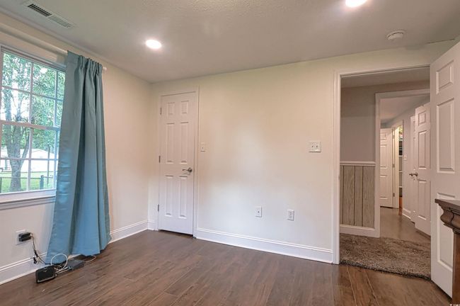 Spare room featuring a smoke detector, dark wood-style flooring, plenty of natural light, and recessed lighting | Image 22