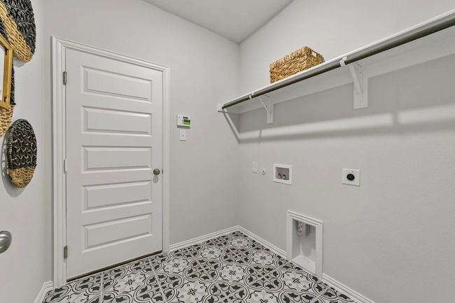 Washroom with electric dryer hookup, hookup for a washing machine, baseboards, and gas dryer hookup | Image 25