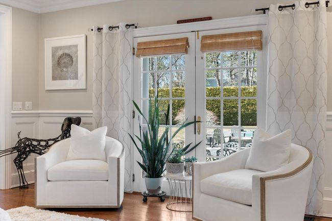 Living area featuring a wainscoted wall, crown molding, wood finished floors, and a decorative wall | Image 16