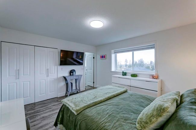 Bedroom featuring wood finished floors and a closet | Image 15