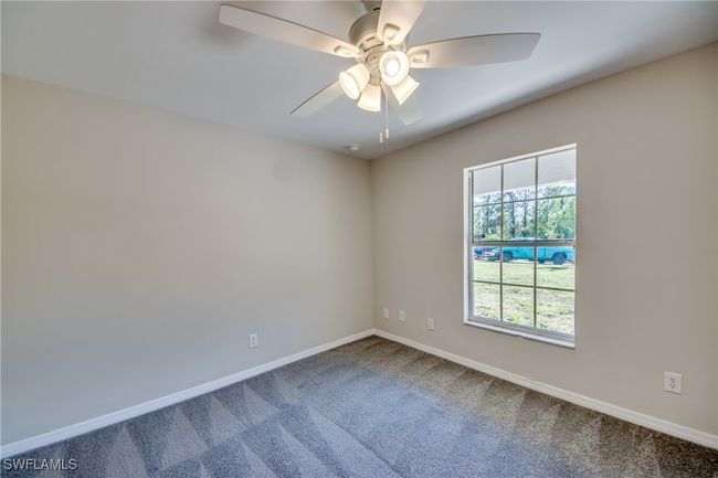 Empty room with carpet floors, ceiling fan, and baseboards | Image 35