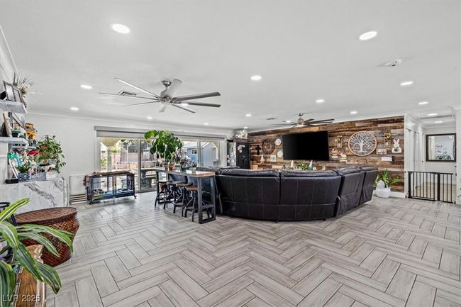 Living area featuring crown molding, recessed lighting, and a ceiling fan | Image 10