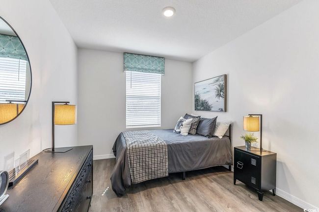 Bedroom featuring wood finished floors and baseboards | Image 21