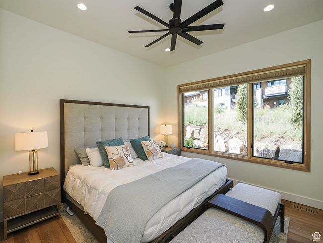Bedroom featuring wood finished floors, recessed lighting, and a ceiling fan | Image 59