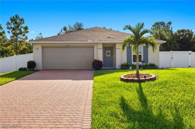 Single story home featuring a garage and a front lawn | Image 1