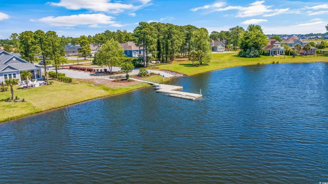 Water view featuring a floating dock and nearby suburban area | Image 16