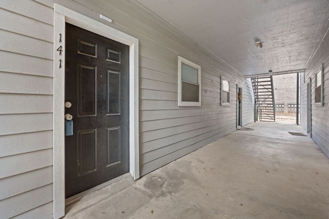 Doorway to property featuring a porch | Image 19