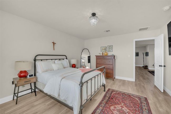 Bedroom with visible vents, light wood-type flooring, and baseboards | Image 17