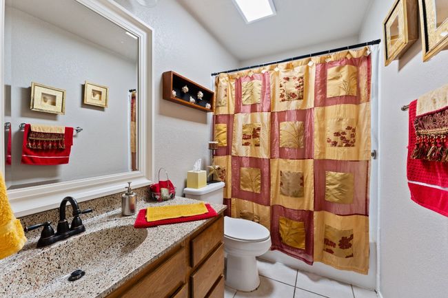 Full bath featuring vanity, tile patterned floors, and shower / bath combination with curtain | Image 14