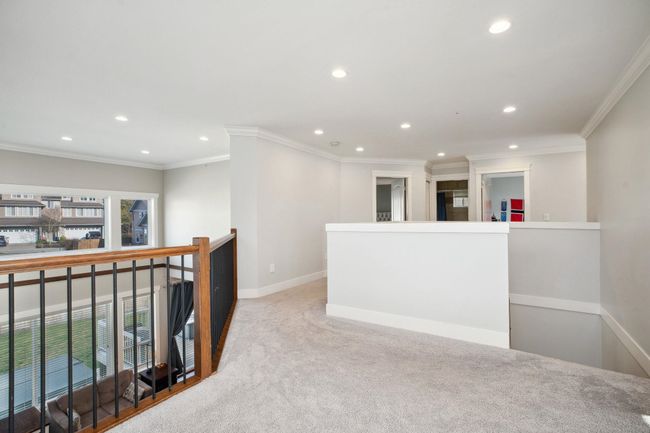 Corridor with baseboards, ornamental molding, recessed lighting, an upstairs landing, and carpet | Image 15