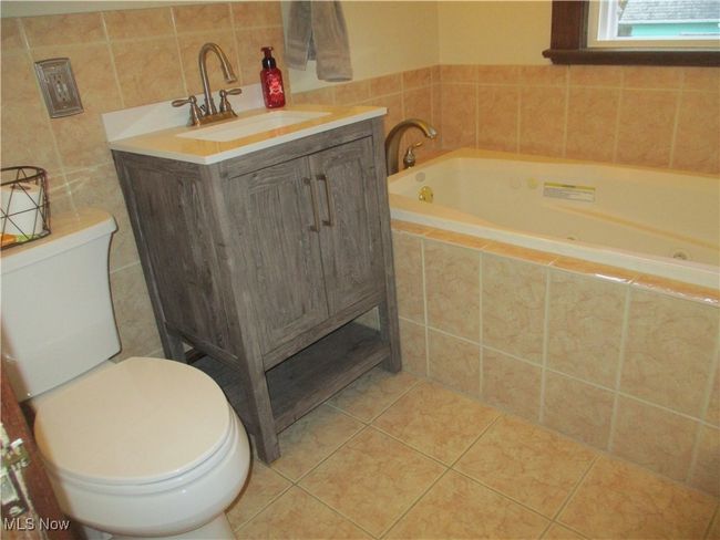 Bathroom with tiled bath and tile floor | Image 23