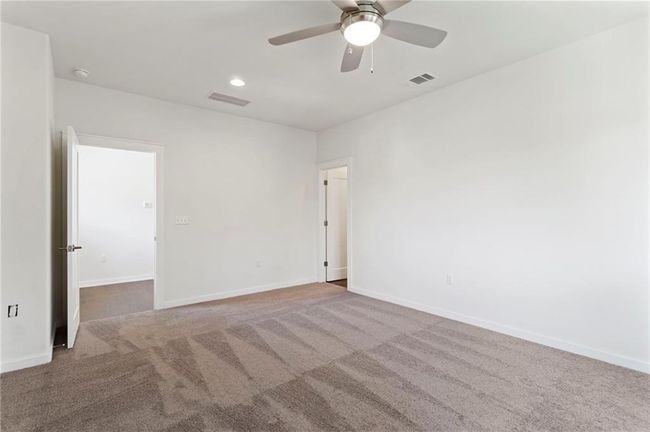 Unfurnished room with carpet flooring, ceiling fan, a smoke detector, and recessed lighting | Image 21