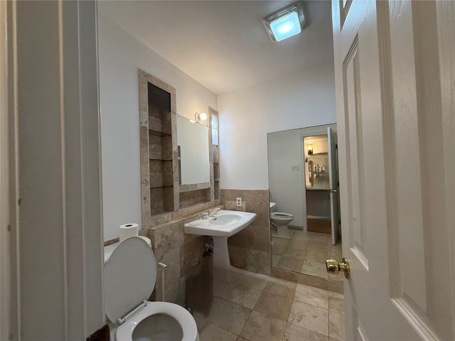 Bathroom featuring tile walls and wainscoting | Image 17