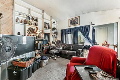 Living area featuring carpet, a textured ceiling, and vaulted ceiling | Image 3