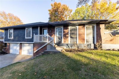 View of front of property with a front yard and a garage | Image 2