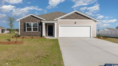 View of front of house with a garage and a front yard | Image 1