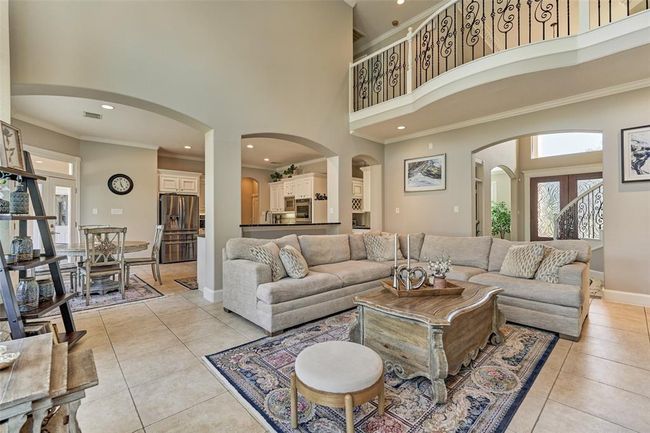 Experience seamless living with this spacious open-concept design, featuring a stylish living room, modern kitchen, and charming breakfast area. | Image 9