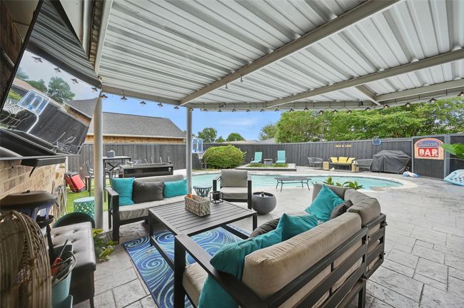 Fenced backyard featuring outdoor lounge area, a patio, and grilling area | Image 30
