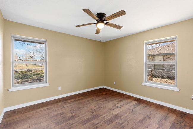 Spare room with a ceiling fan, baseboards, and wood finished floors | Image 20