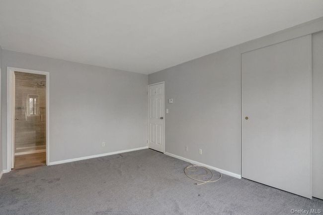 Unfurnished bedroom featuring ensuite bathroom, baseboards, and carpet floors | Image 16