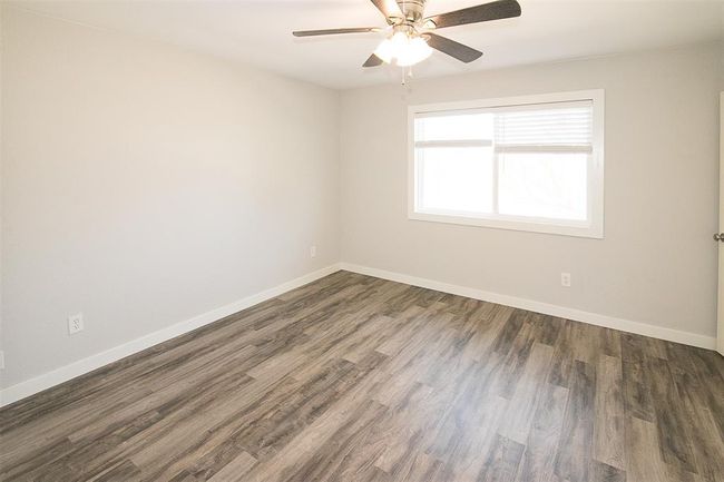 Unfurnished room featuring ceiling fan and wood finished floors | Image 8