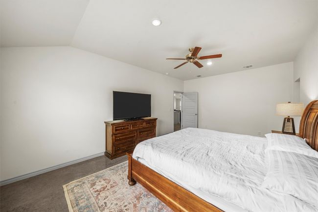 Bedroom with recessed lighting, lofted ceiling, visible vents, a ceiling fan, and carpet flooring | Image 11