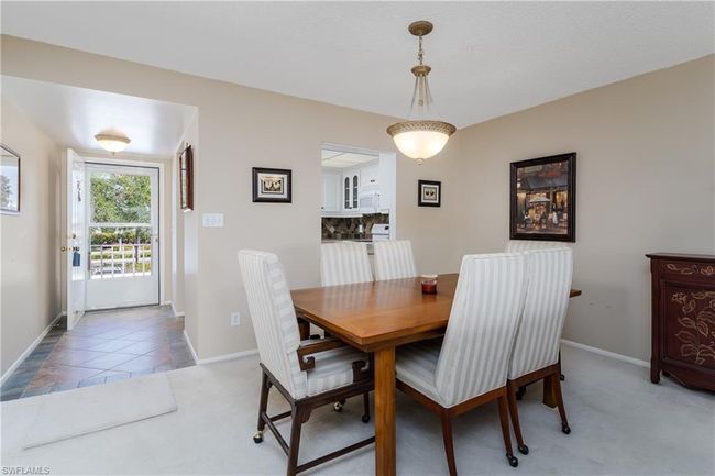 Dining room with baseboards and light colored carpet | Image 15