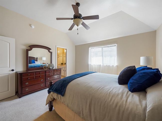 Cozy secondary bedroom with ample natural light and a modern ceiling fan, perfect for comfort and relaxation. | Image 42