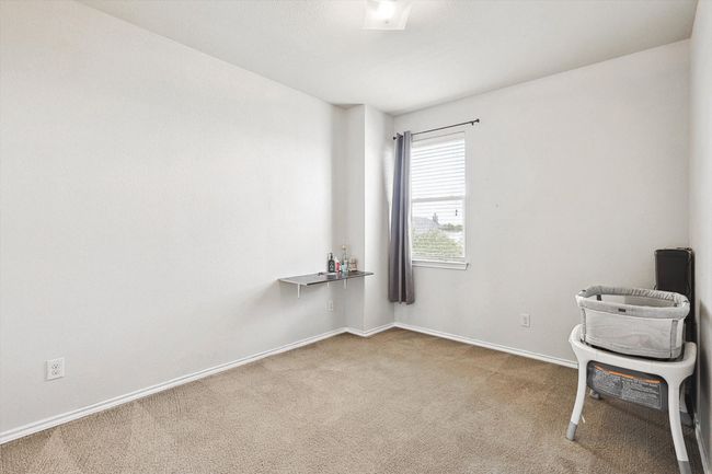 Carpeted empty room featuring baseboards | Image 24