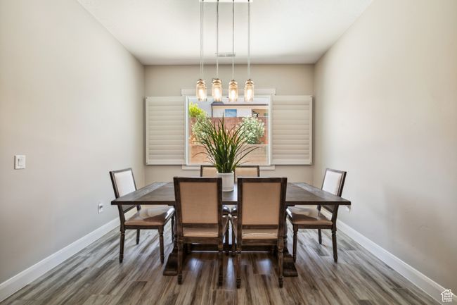 Dining space featuring visible vents, baseboards, and wood finished floors | Image 14