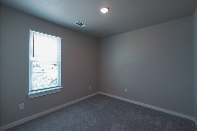 Unfurnished room featuring dark carpet and baseboards | Image 22