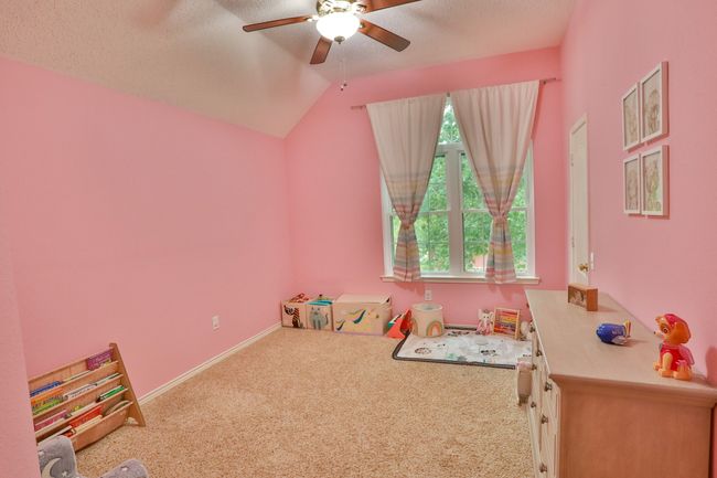 Game room with ceiling fan, carpet, and lofted ceiling | Image 20