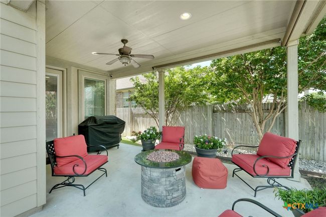 Extended covered patio with high ceilings and ceiling fan | Image 38
