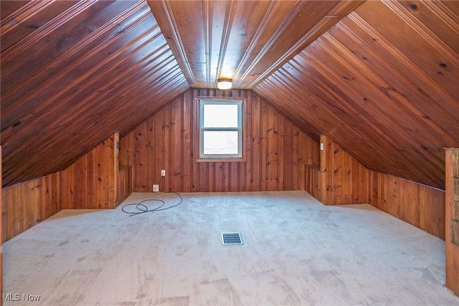 Bonus room with wooden walls, carpet floors, and vaulted ceiling | Image 31