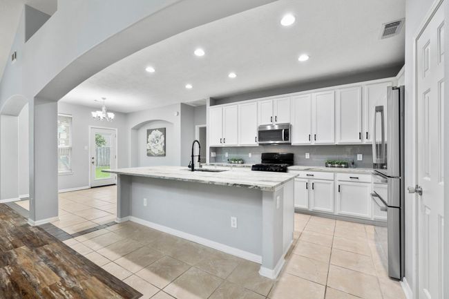 ChatGPT said:Freshly painted cabinetry, a designer backsplash, and leathered granite countertops give the kitchen a crisp, modern edge with timeless appeal. | Image 8