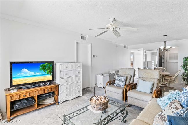 Freshly painted in a neutral, light tone, creating a bright and inviting space ready for your personal touch. With the walls refreshed, the only update needed is your choice of flooring to complete this comfortable and open living space. | Image 18